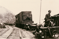 1950,Cargo train. The conductor sat in the trailer and observed fore condition to manipulate the brake.